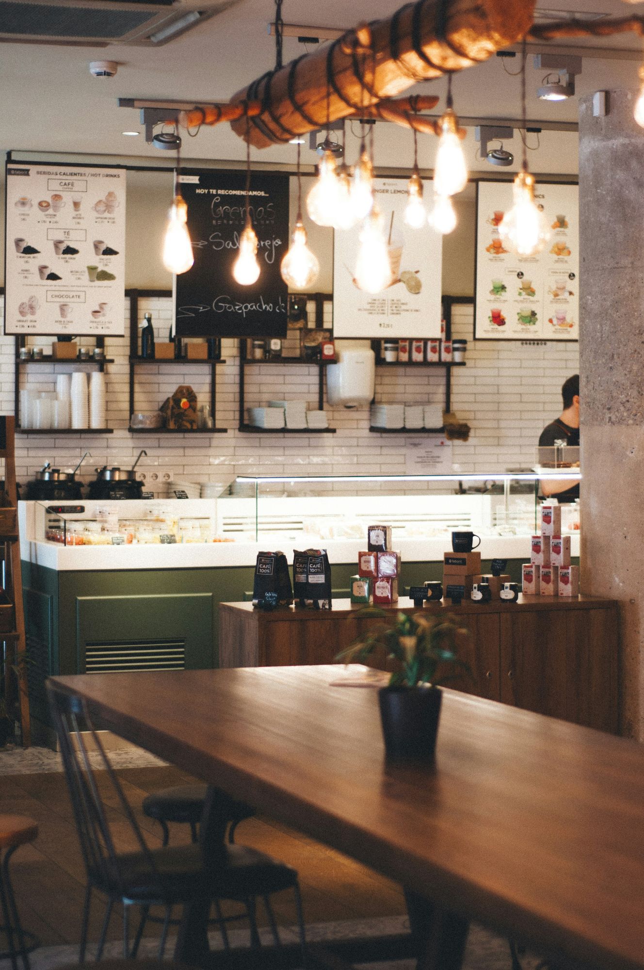 Cafe interior with warm hanging bulbs and timber counter